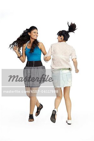 young women playing holding hands