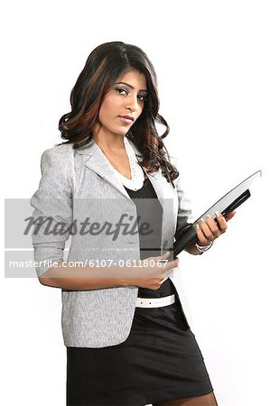 Portrait of young business woman holding file