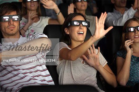 Audience enjoying 3-D movie in theater