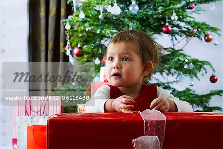 Baby girl opening Christmas present