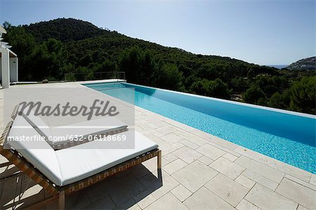 Lounge chairs beside swimming pool