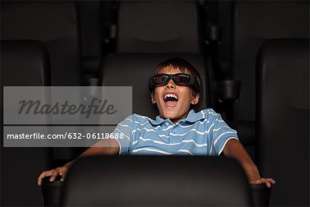 Boy enjoying 3-D movie in theater