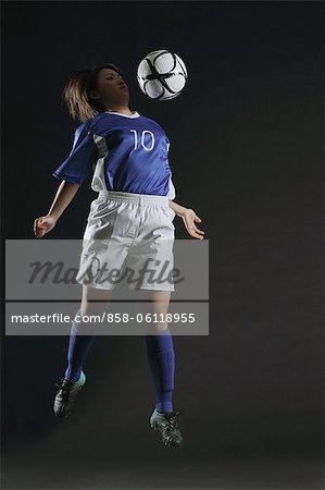 Japanese Woman Playing With Football, Mid Air
