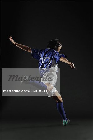 Japanese Young Sportswoman Kicking, Back View