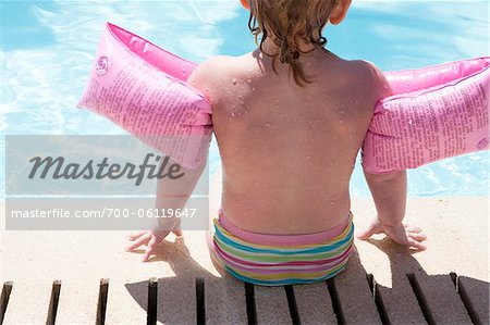 Little Girl Sitting Poolside