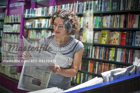 Woman in a magazine shop, main station, Munic, Bavaria, Germany, Europe