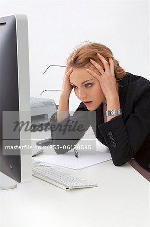 Frustrated young woman in office