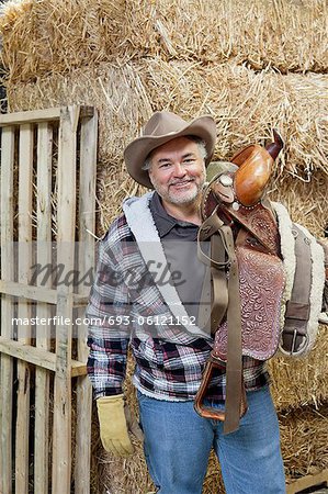 Porträt von glücklich Cowboy Reiten Stift auf der Schulter tragen