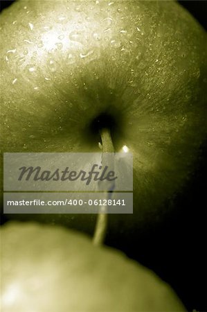 green apples against a black background