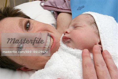 New born baby being held by mother