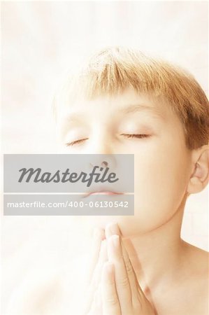 A boy's prayer.... hands together in a prayful or meditative action, aura surrounding him.