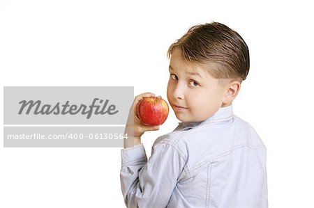 Boy holding an apple looking over his shoulder.  You could replace the apple with another item.