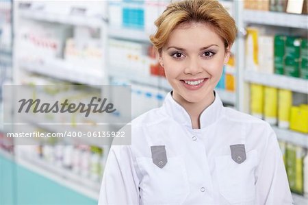 A pharmacist in a pharmacy in uniform
