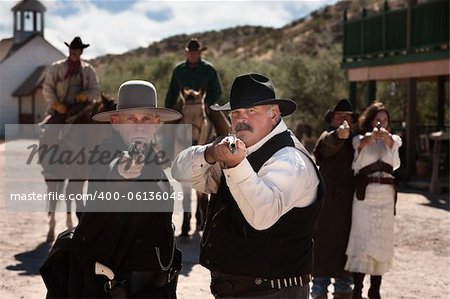 Brave men aim their guns in old west town