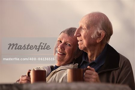 Smiling mature woman with husband in outdoors scene