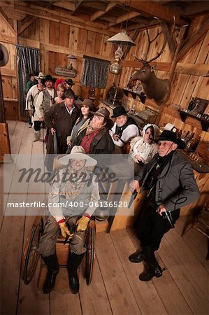 Relaxed customers in old west tavern with weapons at their sides