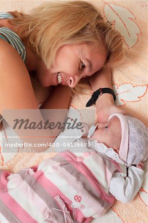 Mother with her newborn baby in home