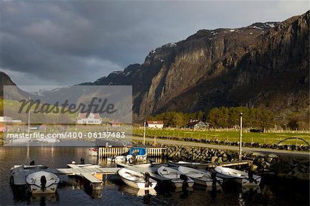 small harbor with mountains in background - evening scene