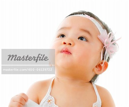Curious asian baby girl looking up, isolated on white background