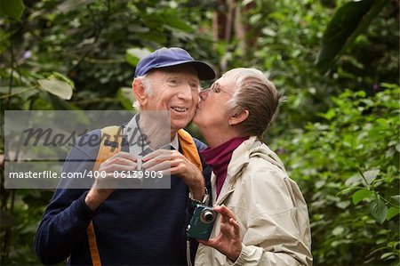 Male and female tourists kissing in the forest