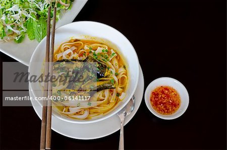 Vietnamese Eel Noodle (Mi Quang) isolated on black background