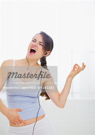 Girl enjoying rock music in bedroom