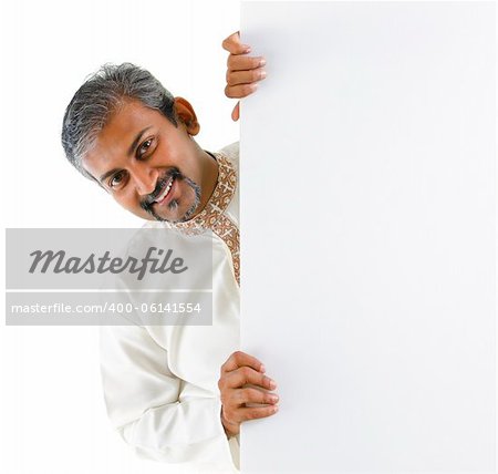 Mature traditional Indian male hiding on a blank space.