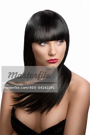 pretty girl with long, dark smooth hair and fringe, she is in front of the camera and looks at left