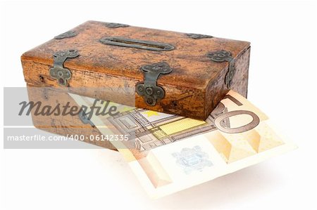 money partly in wooden box over white background