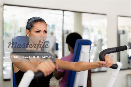 Sports activity, young man and woman exercising and working out in fitness gym