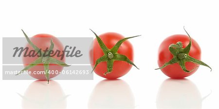 Three tomatoes with reflection isolated on white background