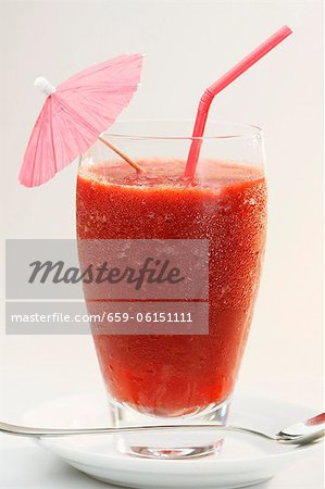 A frozen strawberry daiquiri with a cocktail umbrella