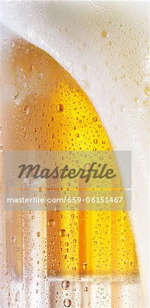 Bier Schaum fließt über den Rand eines Glases (Nahaufnahme) Bier Schaum fließt über den Rand eines Glases (Nahaufnahme)