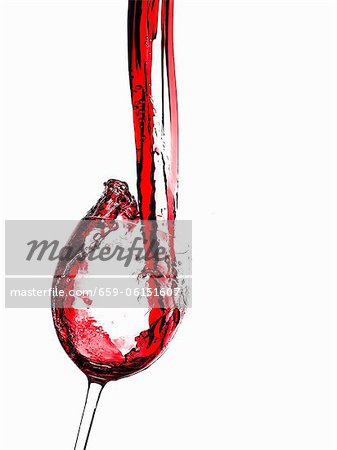 Red Wine Pouring into a Glass From Bottle