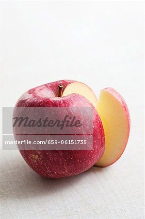 A red apple with a slice removed A red apple with a slice removed
