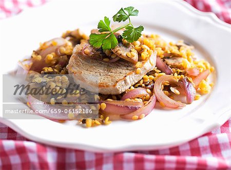 Pork chop with lentils and red onions