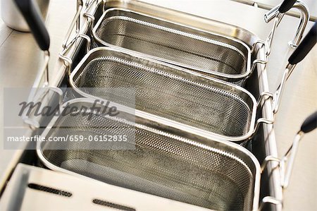 Deep fryers being cleaned with water