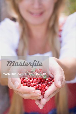 A woman holding lingonberries
