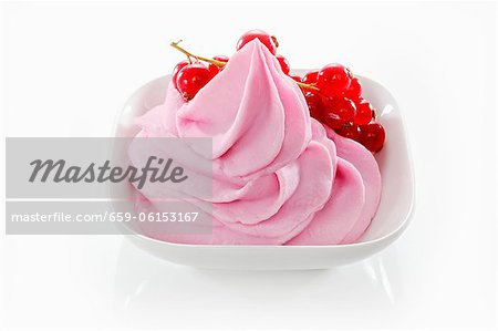 Redcurrant yogurt ice cream garnished with fresh redcurrants