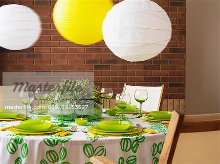 A green and white table with paper lampshades