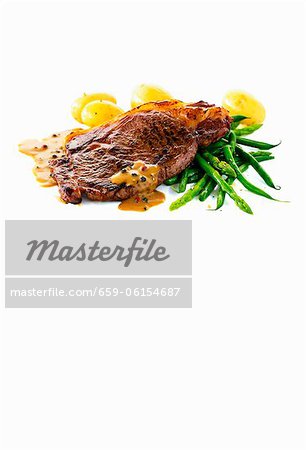 Fried pepper steak with potatoes and green asparagus