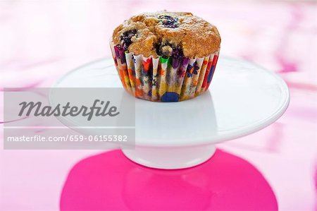 Blueberry Muffin with Colorful Wrapper on Pedestal Dish