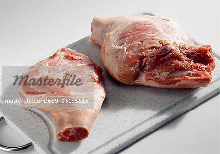 Cochon de lait (shoulder and leg) on a chopping board