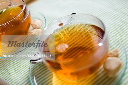 Cups of tea and sugar cubes Cups of tea and sugar cubes