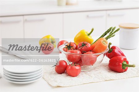 Vegetables And Plates On Kitchen Counter