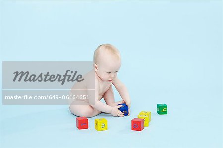 Baby boy playing with colored blocks