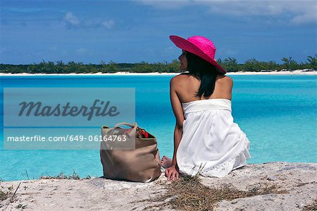 Femme assise sur une plage tropicale