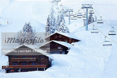 Ski lifts over lodges in snow drift
