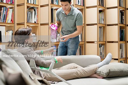 Man giving medicine to his mother