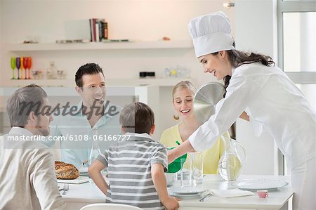 Woman serving lunch at dining table